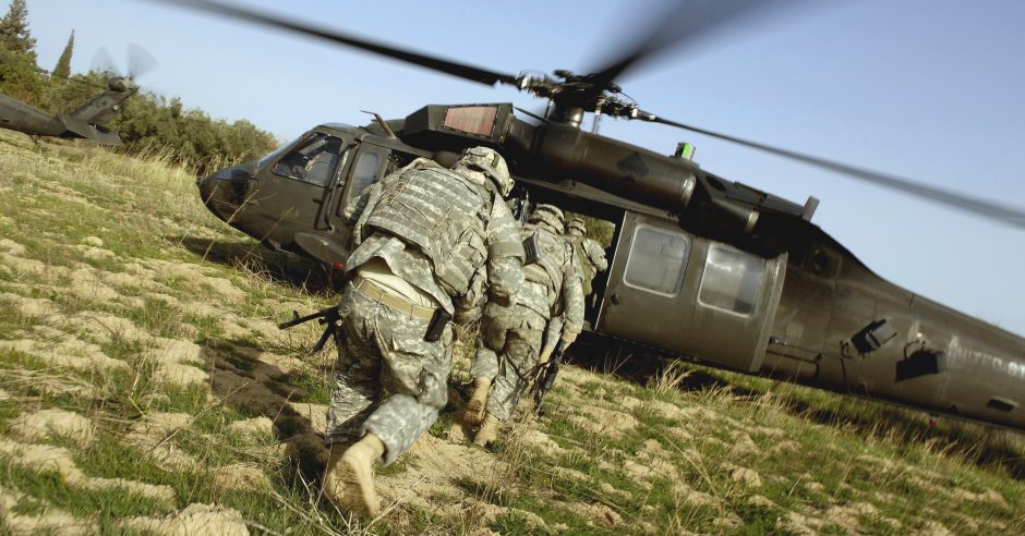 Soldiers prepare to board a UH-60 Black Hawk helicopter.
